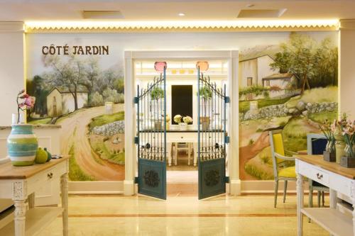 a room with a wall mural of a coffee shop at Coral Beach Resort Sharjah in Sharjah