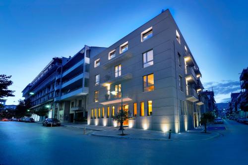 a large building on a city street at night at Lake Spirit Boutique Hotel & Spa in Ioannina