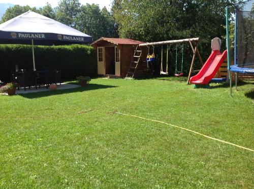 a backyard with a playground and a swing set at Landhaus Tirol in Presseggersee