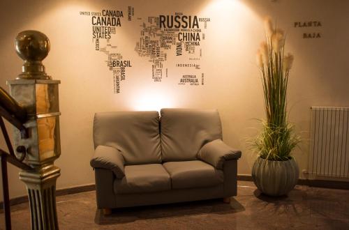 a couch in a room with a wall with words on it at Nueva Colina in Tomiño