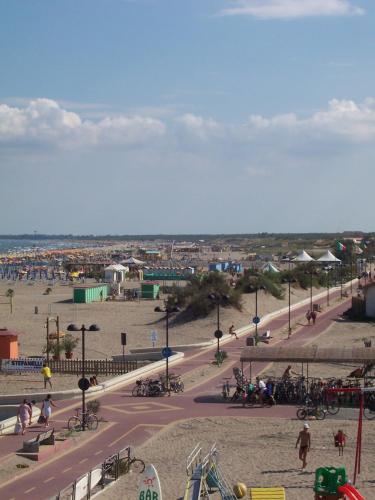 a park with a playground and a roller coaster at Hotel Umberto in Rosolina Mare