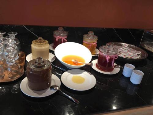 a black counter top with jars and a bowl of eggs at Aenos Hotel in Argostoli