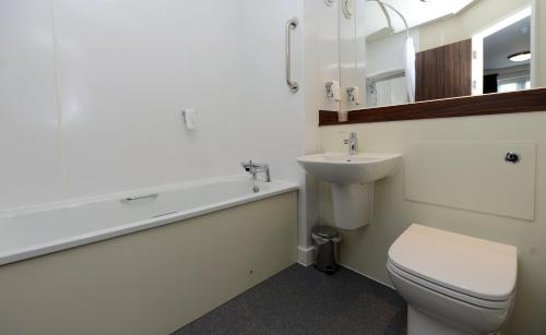a bathroom with a white toilet and a sink at Fallow Field, Telford by Marston's Inns in Telford