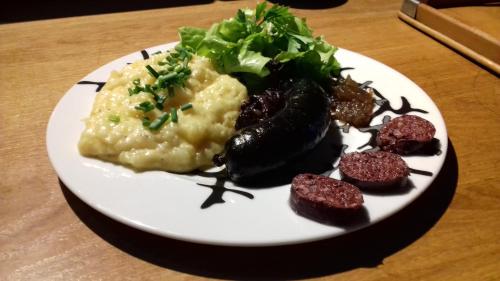 a plate of food with meat and vegetables on a table at Le bourgis in La Chapelle-Montligeon