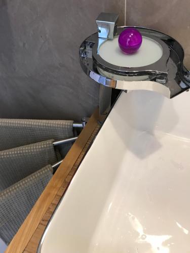 a purple soap sitting on top of a sink at Le Storie di Manarola in Manarola