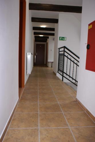 a hallway with a tile floor in a building at Penzion Rozhovice in Rozhovice
