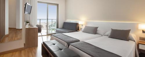 
a hotel room with two beds and a window at RH Bayren Hotel & Spa 4* Sup in Gandía
