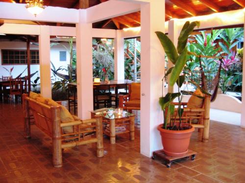 
a patio area with a table, chairs, and tables at Hotel Pura Vida in Puerto Viejo
