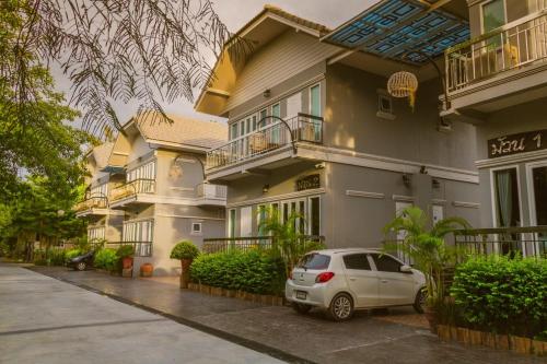 a car parked in front of a building at Muaan Resort in Suphan Buri