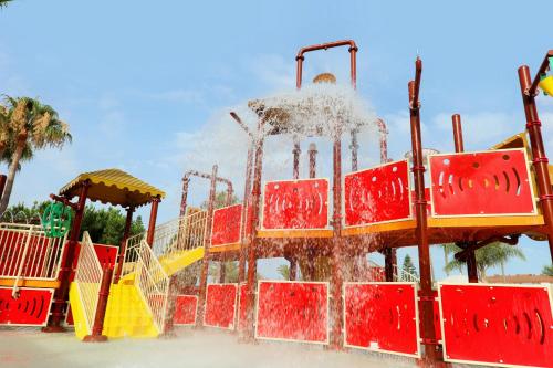 a water park with a playground with a slide at Iberostar Waves Málaga Playa in Torrox Costa