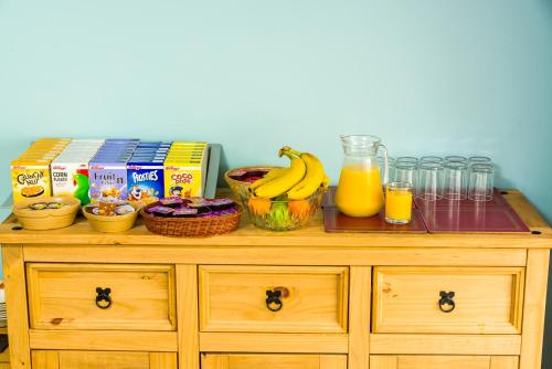 a wooden cabinet with some food and drinks on it at Valdene Hotel in Blackpool