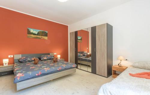a bedroom with a bed with two dogs on it at Apartments Klaudija in Pula