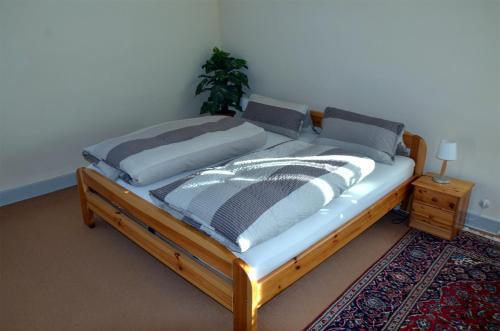 a bedroom with a bed with a wooden frame at Villa Am Rosenfelspark in Lörrach