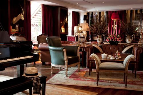 a living room filled with furniture and a piano at Faena Hotel Buenos Aires in Buenos Aires