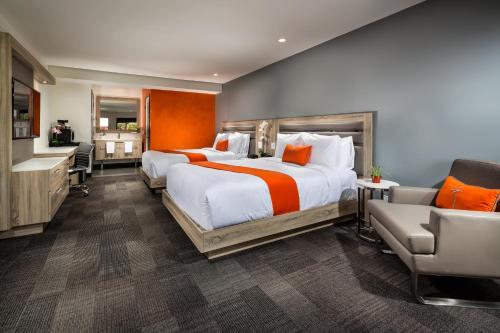 ein großes Schlafzimmer mit 2 Betten und ein Badezimmer in der Unterkunft Canoga Hotel at Warner Center in Canoga Park