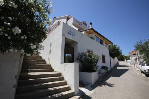 a white building with stairs in front of it at Apartments Barcot in Hvar