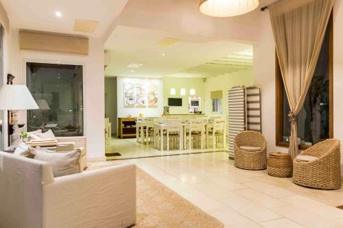 a living room with a couch and a dining room at Kalá Hotel Boutique in Punta del Este
