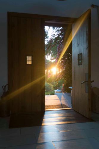 a door to a house with the sun shining through it at Kalá Hotel Boutique in Punta del Este