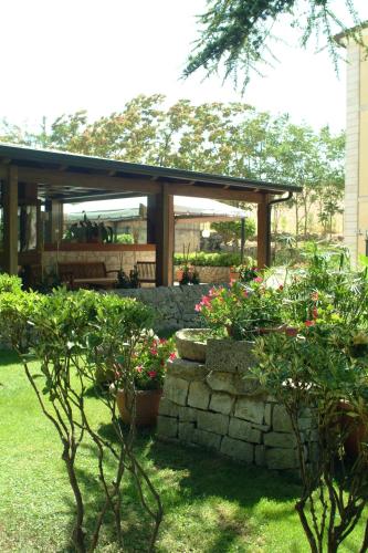 a garden with a pavilion with flowers and plants at Antica Stazione in Chiaramonte Gulfi