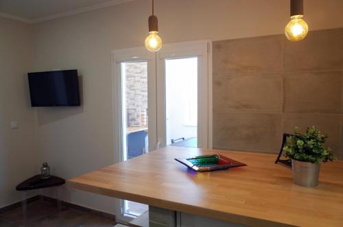 a room with a wooden table and a window at Lisbon Beach Apartments 4 in Costa da Caparica