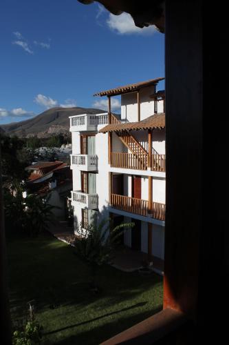 a large white building with balconies on the side of it at La Quinta San Andrés in Ibarra