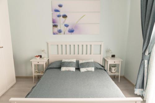 a bedroom with a bed with two night stands at Floreo Guest House in Rome