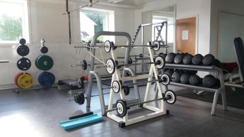 a gym with a bunch of weights on a rack at Molde Vandrerhjem Hostel in Molde