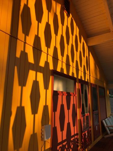 a shadow of a building with a pattern on the wall at Snowdon Chalet Motel in Londonderry