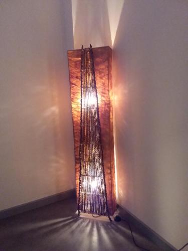 a light in the corner of a room at L'Orchidée in Lassay