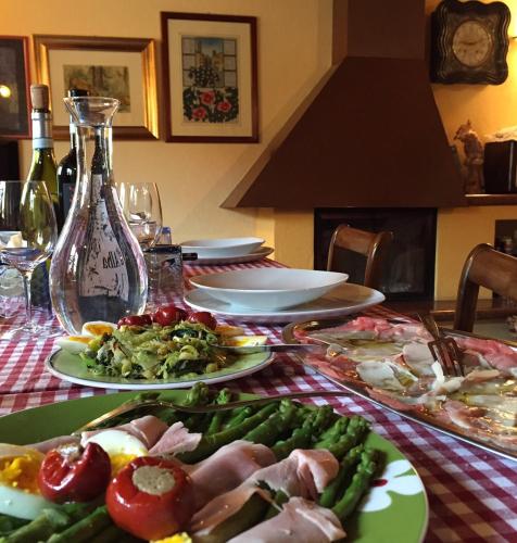 a table with plates of food on a table at Cascina Baresane in Alba