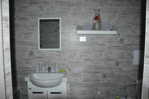 a bathroom with a sink and a mirror at Alanta in Druskininkai