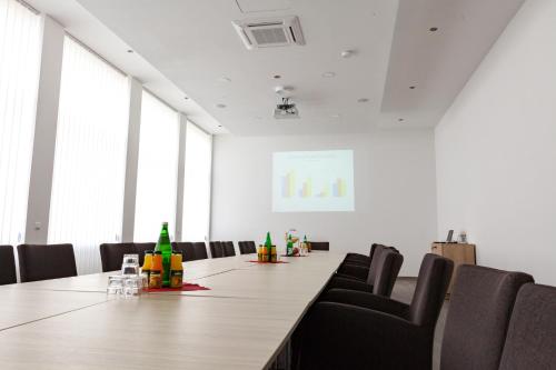 a conference room with a long table and chairs at Ruhr Inn Hotel in Hattingen