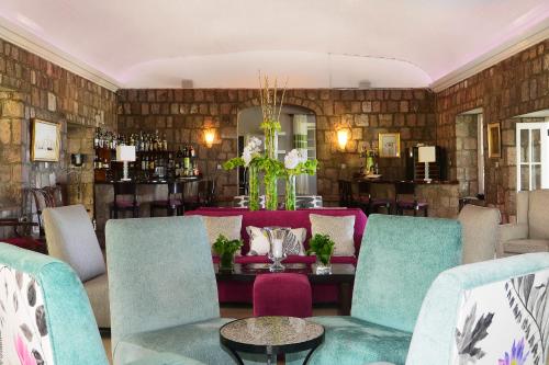 a dining room with blue chairs and a table at Montpelier Plantation & Beach in Nevis