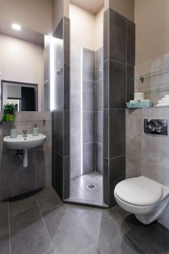 a bathroom with a shower and a toilet and a sink at Happy Tower in Krakow
