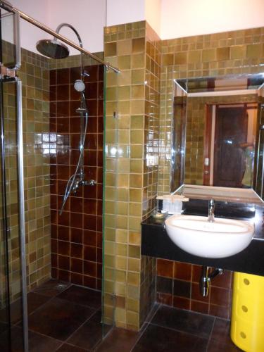 a bathroom with a sink and a shower at VC@Suanpaak Boutique Hotel & Service Apartment in Chiang Mai