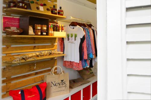 a walk in closet with clothes and a bag at Montpelier Plantation & Beach in Nevis