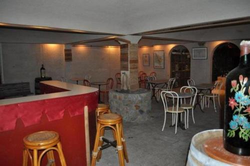 a restaurant with tables and chairs and a bar at Le Relais de la Maroto in Pirae