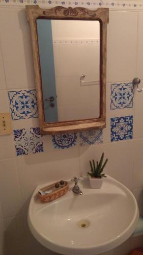 a bathroom with a sink and a mirror on the wall at Bed & breakfast Villa Carmo in Salvador