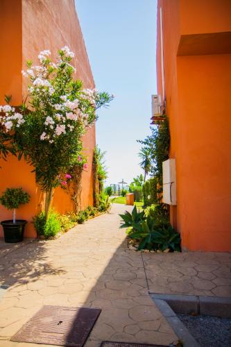 an alley with flowers on the side of a building at Manilva Beach 140 in Manilva