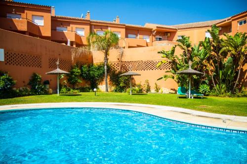 a swimming pool in front of a building at Manilva Beach 140 in Manilva