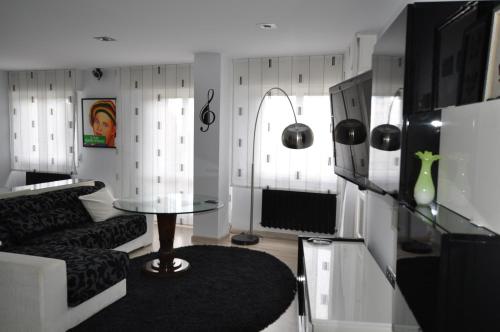 a living room with a couch and a table at Black and White Suitte "Marques" in Noja