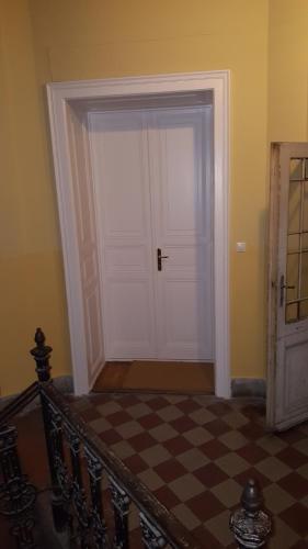 a door in a room with a checkered floor at Dob Twenty Rooms in Budapest
