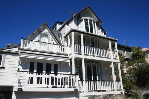a large white house with a white balcony at The Terrace Villas Serviced Apartments in Wellington