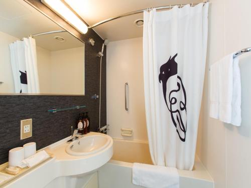 a bathroom with a shower curtain with a horse head on it at The Green Leaf, Niseko Village in Niseko