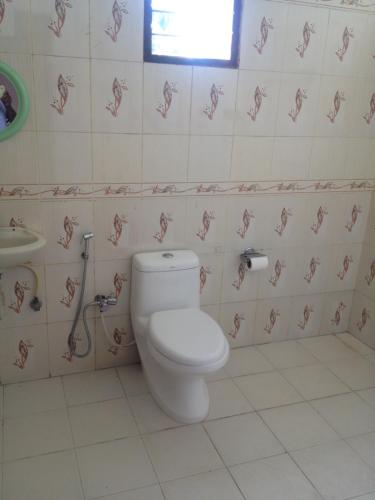 a bathroom with a toilet and a sink at Palakal Residency in Cochin
