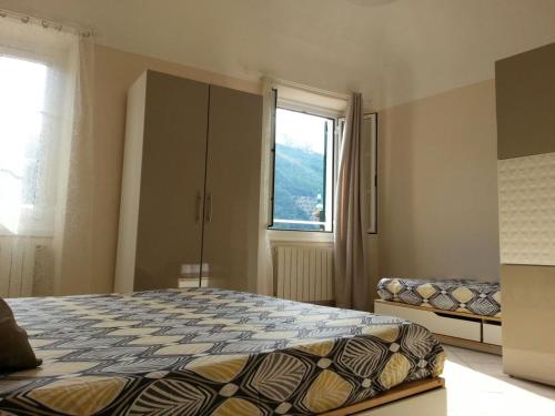 a bedroom with a bed and a window at La Dimora del Sole in Finale Ligure