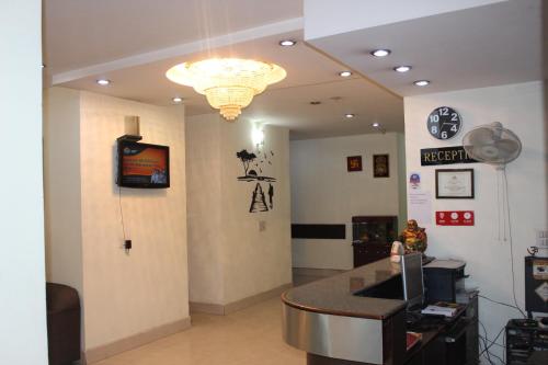a waiting room with a clock on the wall at Hotel Dreamz Residency in Karnāl