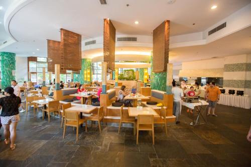 a restaurant with people sitting at tables at Sunshine Resort Intime Sanya in Sanya