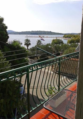 a view of the water from a balcony with a table at Apartments Anita in Srima