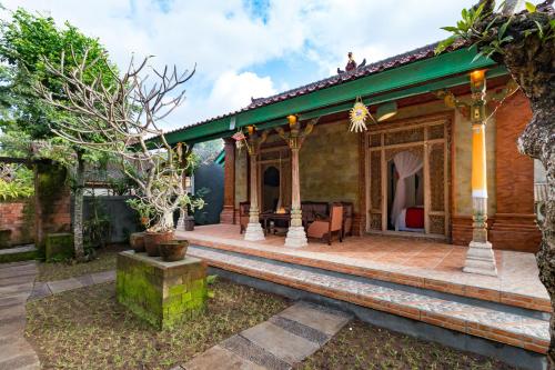 a home with a patio and a house at Umasari Rice Terrace Villa by AGATA in Tabanan